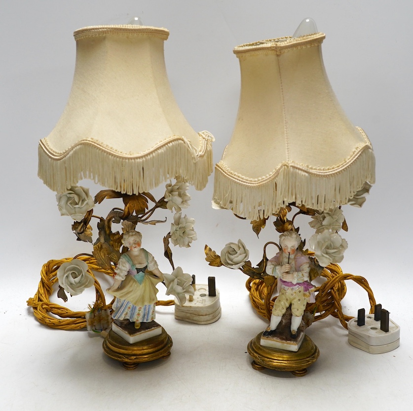 A pair of German figural porcelain and ormolu mounted table lamps with shades, overall 32cm high. Condition - fair to good, minor losses